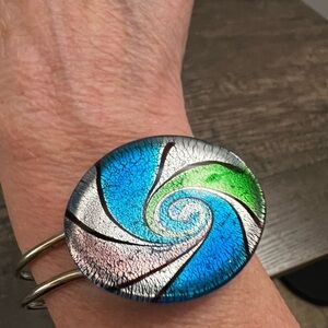 Elegant Silvertone clamper bracelet with green and Blue Glass swirl pattern